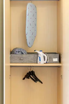 a closet with a shelf with a tie and utensils at Bilocale in Centro in Palermo