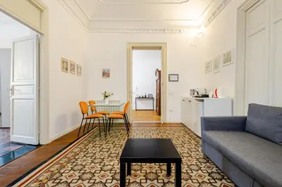 a living room with a couch and a table at Bilocale in Centro in Palermo