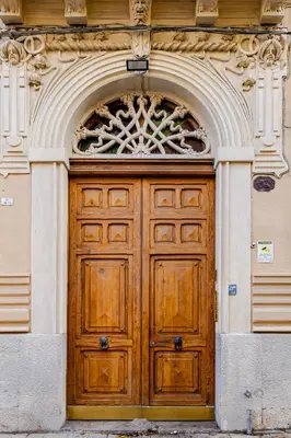 a large wooden door in a building at Bilocale in Centro in Palermo
