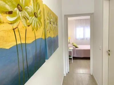 a room with a painting of flowers on the wall at Residence Le Rose in Castellammare del Golfo
