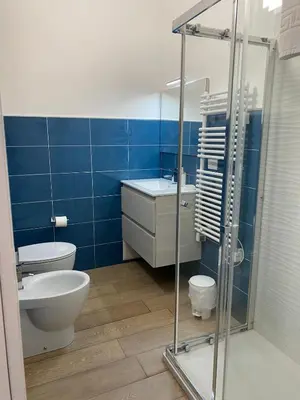 a bathroom with a toilet and a sink and a shower at Residence Le Rose in Castellammare del Golfo