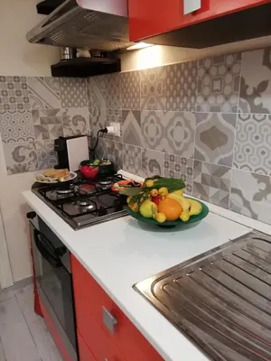 a kitchen with a plate of fruit on a counter at Appartamenti La Stella in Castellammare del Golfo