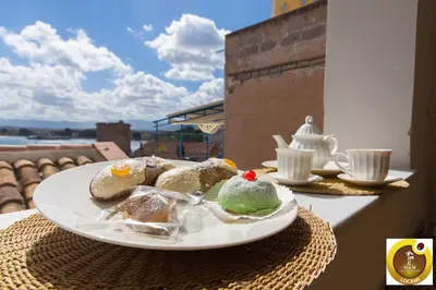 a plate of desserts on a table with a view at Holiday & House - Imparato Vacanze Prestige Mondello in Mondello