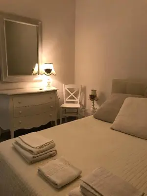 a bedroom with a bed and a dresser and a mirror at Holiday & House - Imparato Vacanze Prestige Mondello in Mondello
