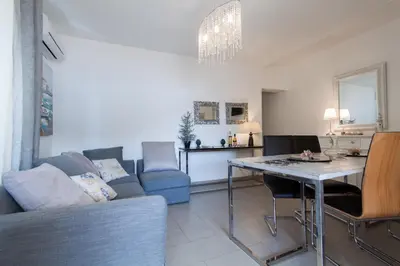 a living room with a couch and a table at Holiday & House - Imparato Vacanze Prestige Mondello in Mondello