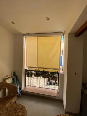 a window with a yellow curtain in a living room at Holiday & House - Imparato Vacanze Prestige Mondello in Mondello
