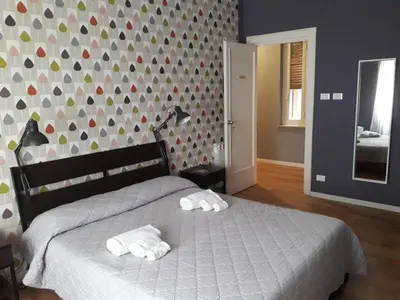 a bedroom with a bed with two towels on it at Zammù in Palermo