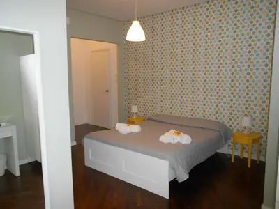 a bedroom with a bed with two towels on it at Zammù in Palermo