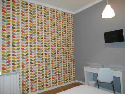 a bedroom with a wall covered in colorful polka dots at Zammù in Palermo