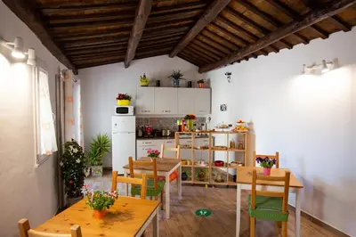 a kitchen with wooden tables and chairs in a room at Quattro Incanti in Palermo