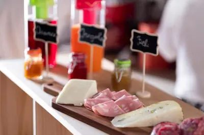 a table with cheese and meats on a cutting board at Quattro Incanti in Palermo