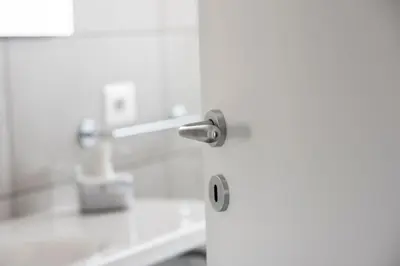 a white door with a metal knob on it at B&B Attico 33 in Palermo