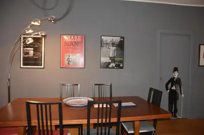 a dining room table with chairs and posters on the wall at Luci della città Palazzo San Matteo in Palermo