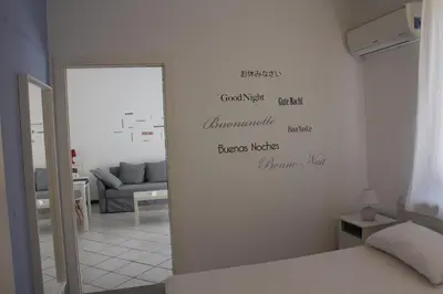 a living room with a white wall with writing on it at A un passo dal mare in Lido di Mondello