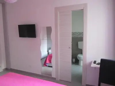 a room with a sliding glass door with a television at Casa Normanna in Monreale