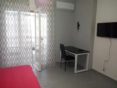 a bedroom with a desk and a bed and a television at Casa Normanna in Monreale