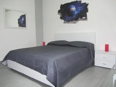 a bedroom with a bed and a mirror on the wall at Casa Normanna in Monreale