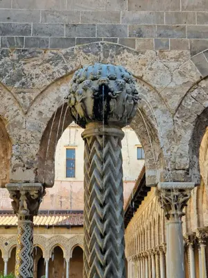 a statue in front of a building at Casa Normanna in Monreale