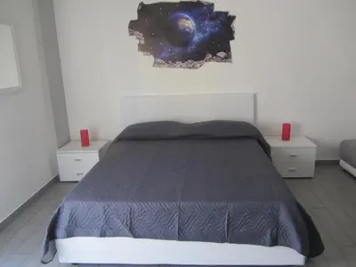 a bedroom with a bed and two night stands at Casa Normanna in Monreale