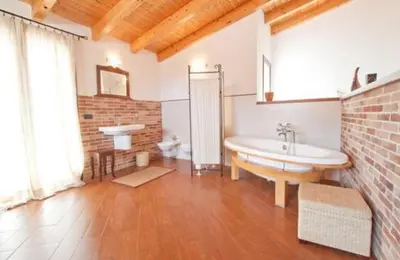 a kitchen with a table and a refrigerator at Case Vacanza Cipriano spacious apartment and cosy studio monolocale in Torretta