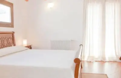 a bedroom with a large bed and a window at Case Vacanza Cipriano spacious apartment and cosy studio monolocale in Torretta