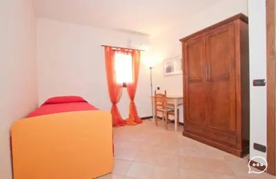 a bedroom with a bed with a comforter on it at Case Vacanza Cipriano spacious apartment and cosy studio monolocale in Torretta
