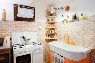 a small kitchen with a sink and a stove at Case Vacanza Cipriano spacious apartment and cosy studio monolocale in Torretta