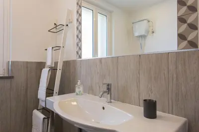 a bathroom with a sink and a mirror at Nonna Anna Rooms in Palermo