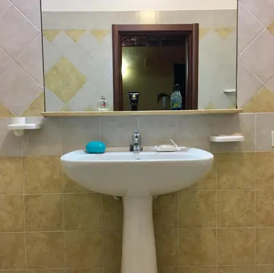 a bathroom with a sink and a mirror at Al Duomo in Partinico