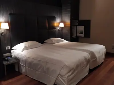 a bedroom with a large bed with white sheets and pillows at Hotel Porta Felice & Spa in Palermo