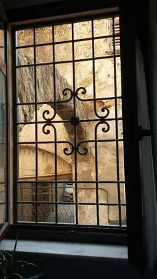a window with a view of a car outside at b&b Caravella in Mezzojuso
