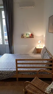 a bedroom with two beds and a window at Duchi in Palermo