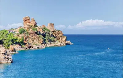 an island in the ocean with a castle on it at Palermo Per Due in Torretta