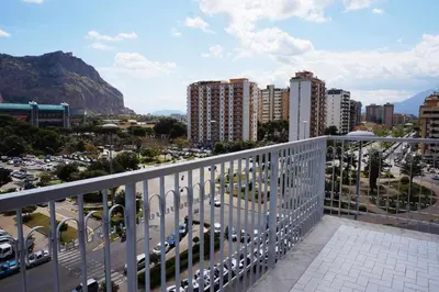 a balcony with a view of a city at Favorita suites in Palermo