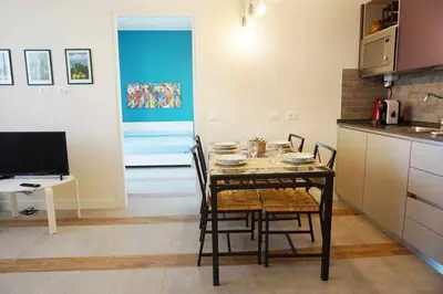a dining room with a table and chairs in a kitchen at Favorita suites in Palermo