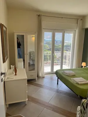 a bedroom with a bed and a view of a balcony at Favorita suites in Palermo