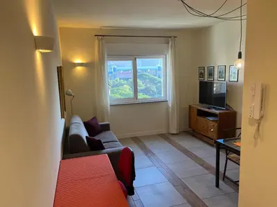 a living room with a couch and a television at Favorita suites in Palermo
