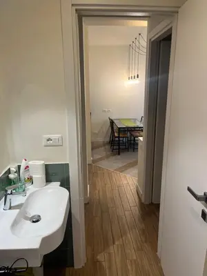 a bathroom with a sink and a dining room at Favorita suites in Palermo