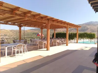 a group of tables and chairs under a pavilion at Agriturismo le Campanelle - Sicilia - Cefalù in Lascari
