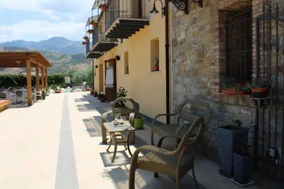 a patio with chairs and a table on a building at Agriturismo le Campanelle - Sicilia - Cefalù in Lascari