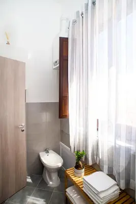 a bathroom with a toilet and a sink at Capo House in Palermo