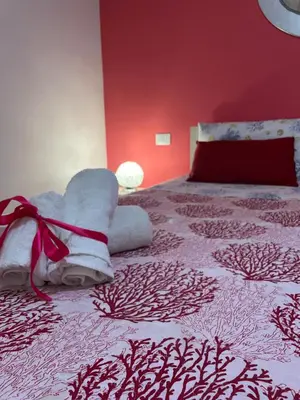 a bedroom with a bed with a stuffed animal on it at Casa Vacanze Aurora in Balestrate