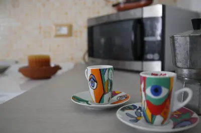 two coffee cups sitting on a kitchen counter at Casa Vacanze Aurora in Balestrate
