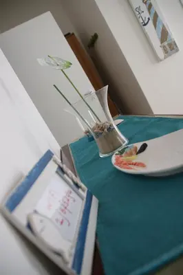 a table with a vase and a plate on it at Casa Vacanze Aurora in Balestrate
