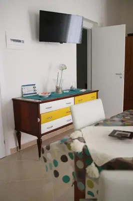 a living room with a dresser with a tv on it at Casa Vacanze Aurora in Balestrate