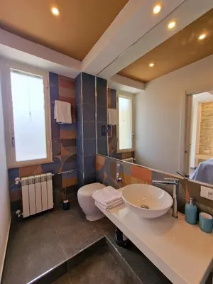 a bathroom with a sink and a toilet at Mongibello Palace B&B in Mondello