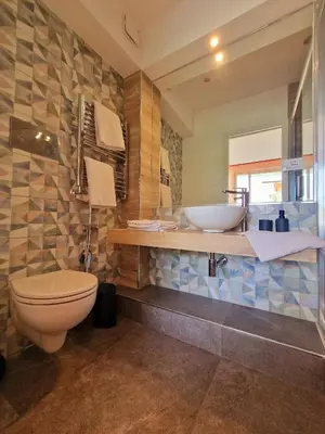 a bathroom with a toilet and a sink at Mongibello Palace B&B in Mondello