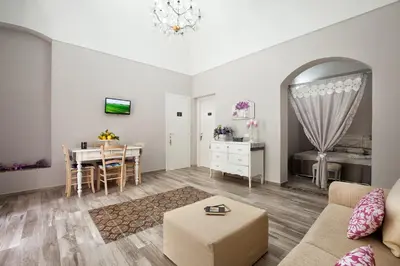 a living room with a couch and a table at Le Alcove in Cinisi