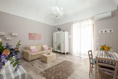 a living room with a couch and a table at Le Alcove in Cinisi