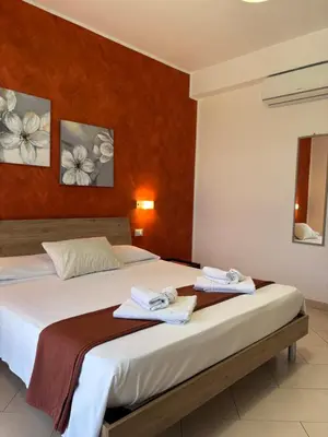 a bedroom with a bed with towels on it at B&B La Chiocciola in Castelluzzo
